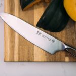 silver knife on wooden board