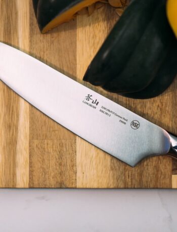 silver knife on wooden board