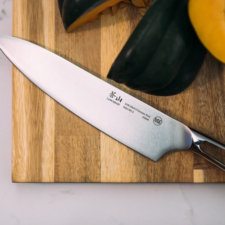 silver knife on wooden board