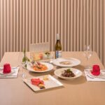 A beautifully arranged dining table with gourmet dishes, offering a fine dining experience with elegant presentation.