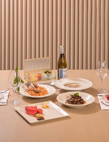 A beautifully arranged dining table with gourmet dishes, offering a fine dining experience with elegant presentation.