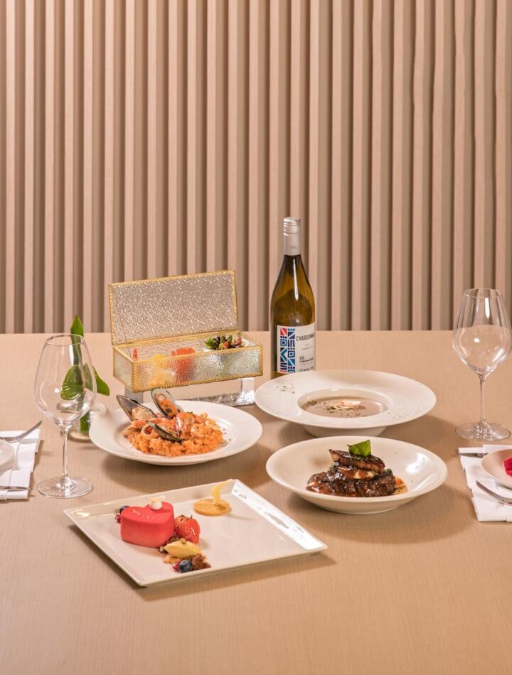 A beautifully arranged dining table with gourmet dishes, offering a fine dining experience with elegant presentation.