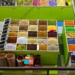 Colorful spices and dried goods displayed in market stalls.