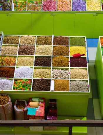 Colorful spices and dried goods displayed in market stalls.