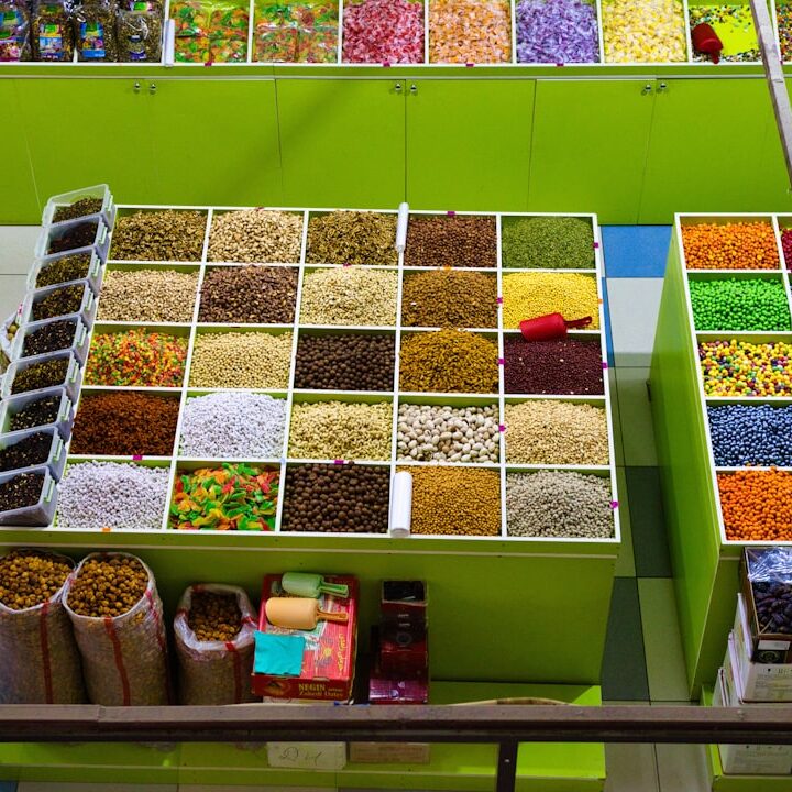 Colorful spices and dried goods displayed in market stalls.