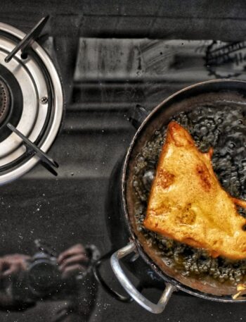 a frying pan filled with food on top of a stove