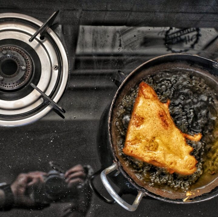 a frying pan filled with food on top of a stove