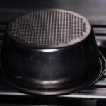 An espresso machine's filter basket is visible.