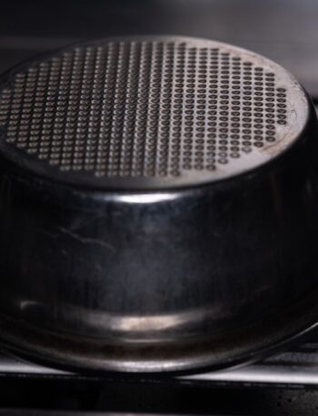 An espresso machine's filter basket is visible.