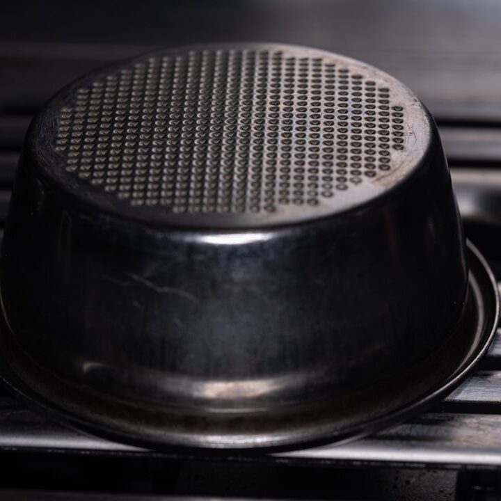 An espresso machine's filter basket is visible.