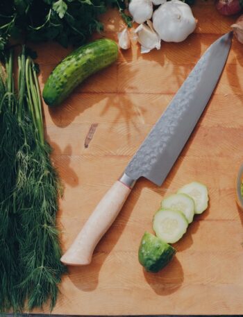 sliced cucumber and green vegetable on brown wooden table