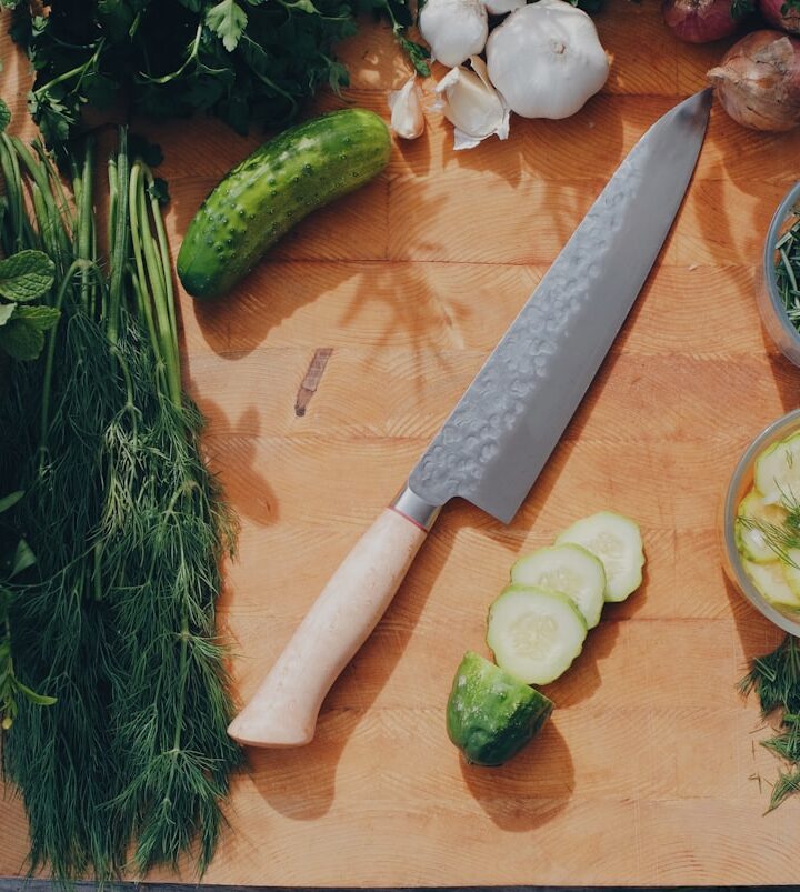 sliced cucumber and green vegetable on brown wooden table