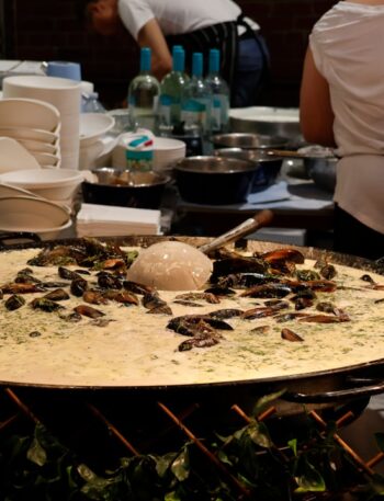 Large pan of food with mussels and rice
