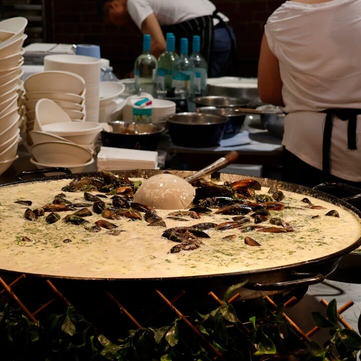 Large pan of food with mussels and rice