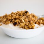 a bowl of granola and yogurt with a spoon