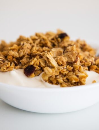 a bowl of granola and yogurt with a spoon