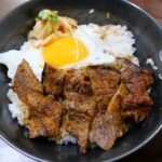 Bowl of rice with grilled meat and fried egg