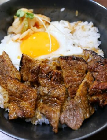 Bowl of rice with grilled meat and fried egg