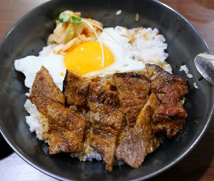 Bowl of rice with grilled meat and fried egg