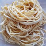 white pasta on white ceramic plate