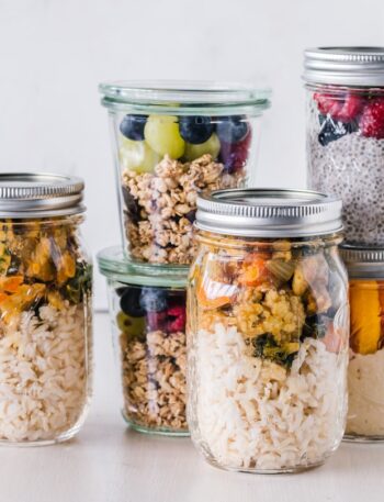 six full clear glass jars on white surface