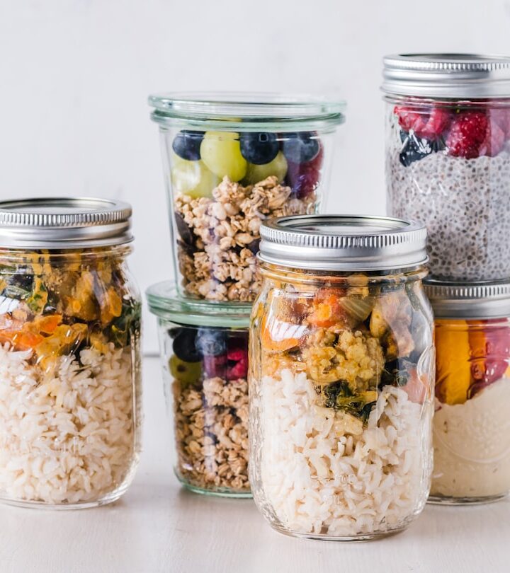 six full clear glass jars on white surface