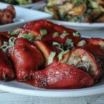 a white plate topped with meat covered in sauce