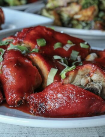 a white plate topped with meat covered in sauce