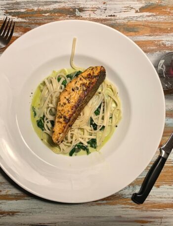 a white plate topped with pasta and chicken