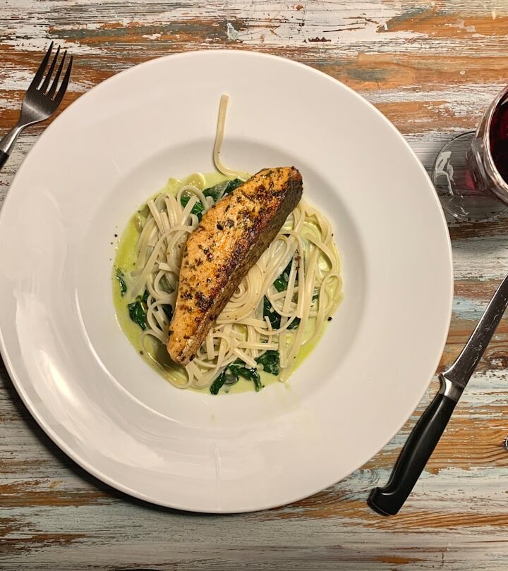 a white plate topped with pasta and chicken