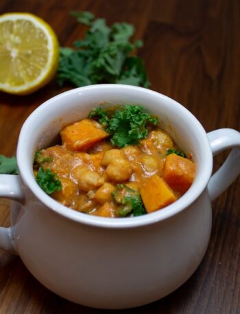 a bowl of food on a table next to a lemon
