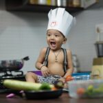 girl in black and white polka dot tank top eating