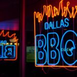 a neon sign that is on the side of a building