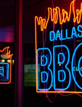 a neon sign that is on the side of a building
