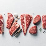 a group of raw meats on a table