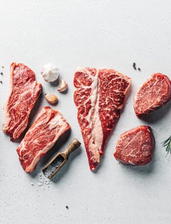 a group of raw meats on a table