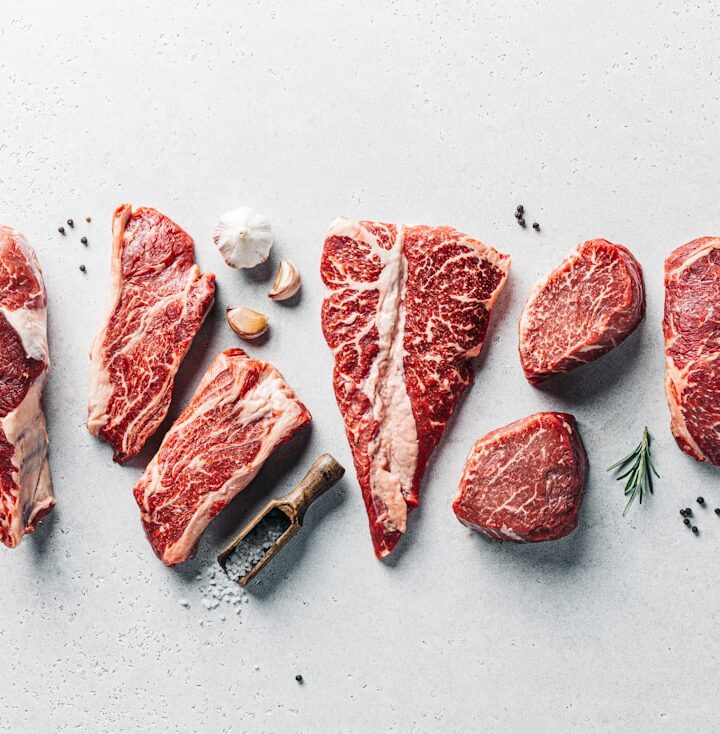 a group of raw meats on a table